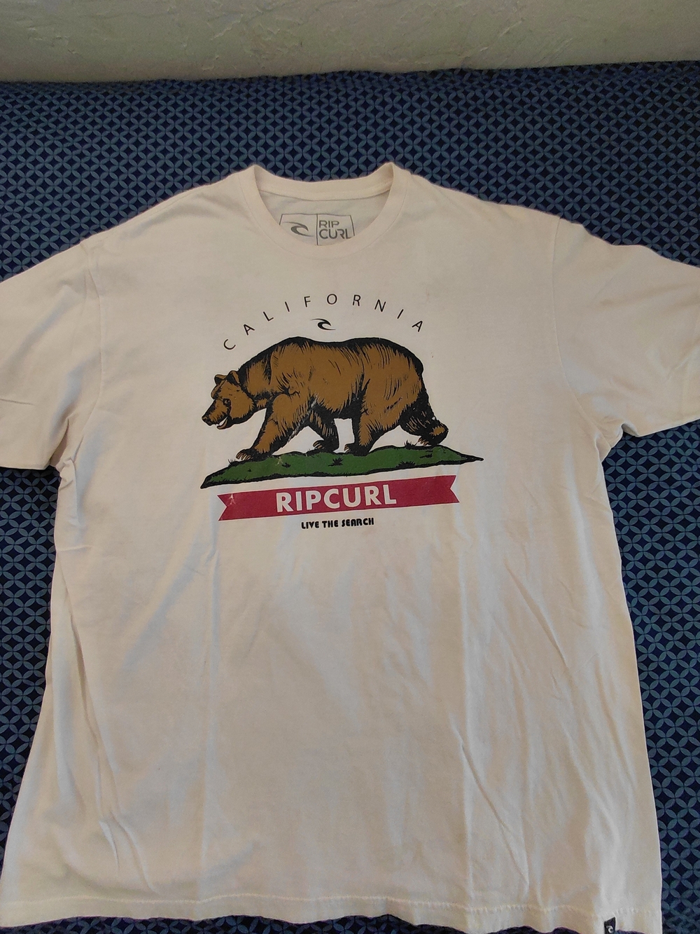 Rip Curl White Short-Sleeve Tee with Brown Bear Graphic and Red Banner